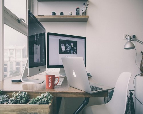 Organized home office desk with natural light